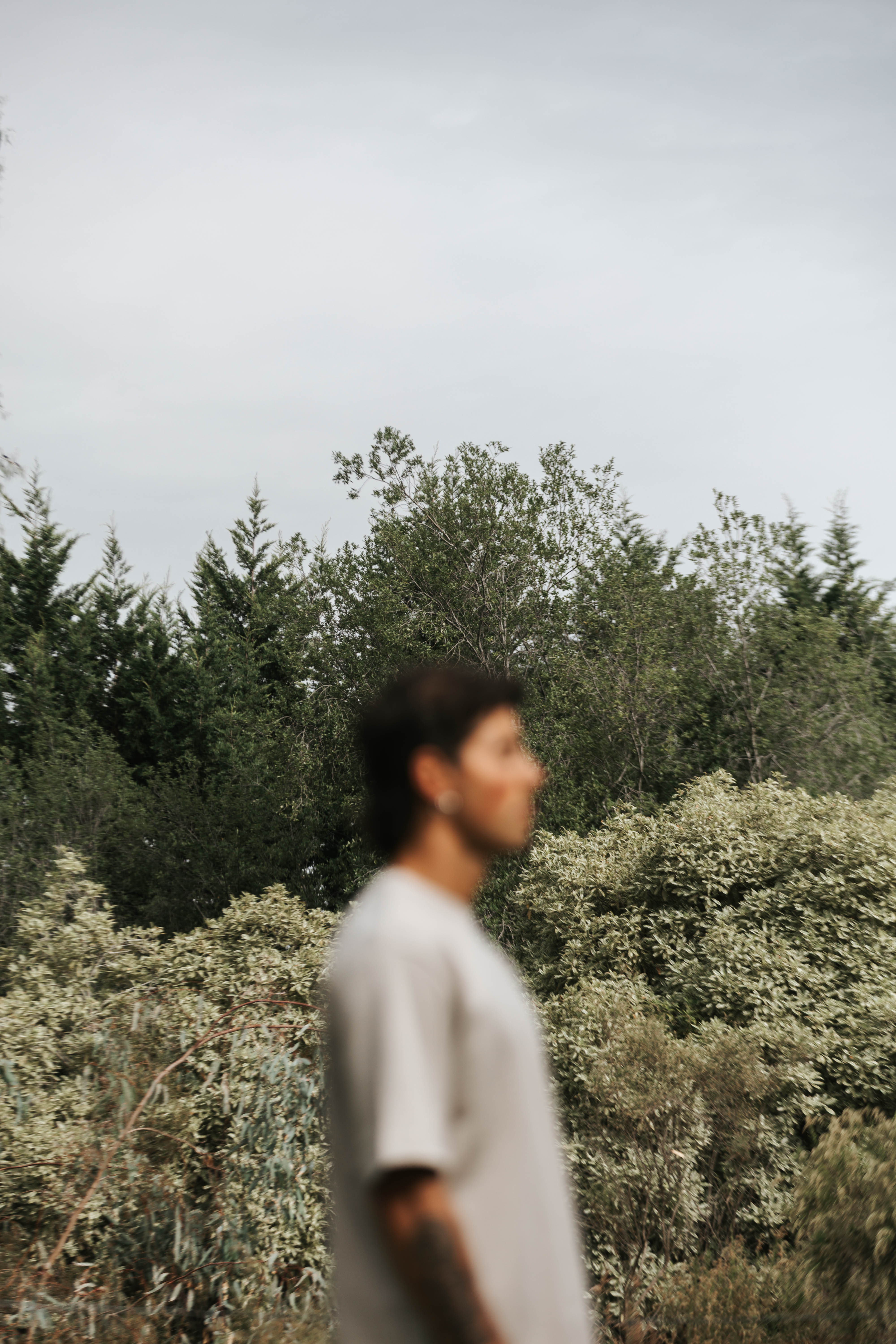 Tristan softly framed against trees — stillness as the place you find yourself